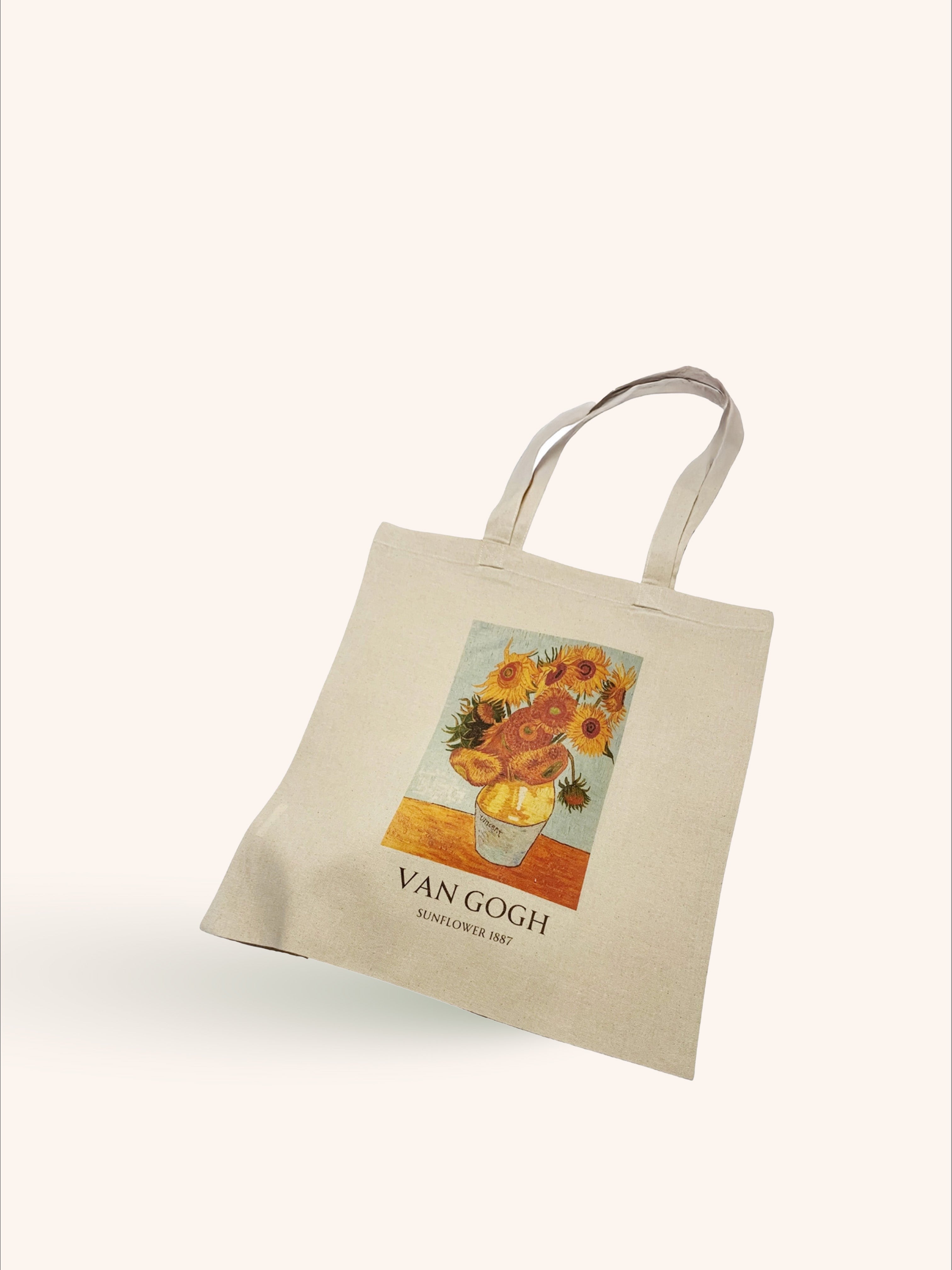 A beige tote bag with a vintage floral print in the center, displayed against a white background.
