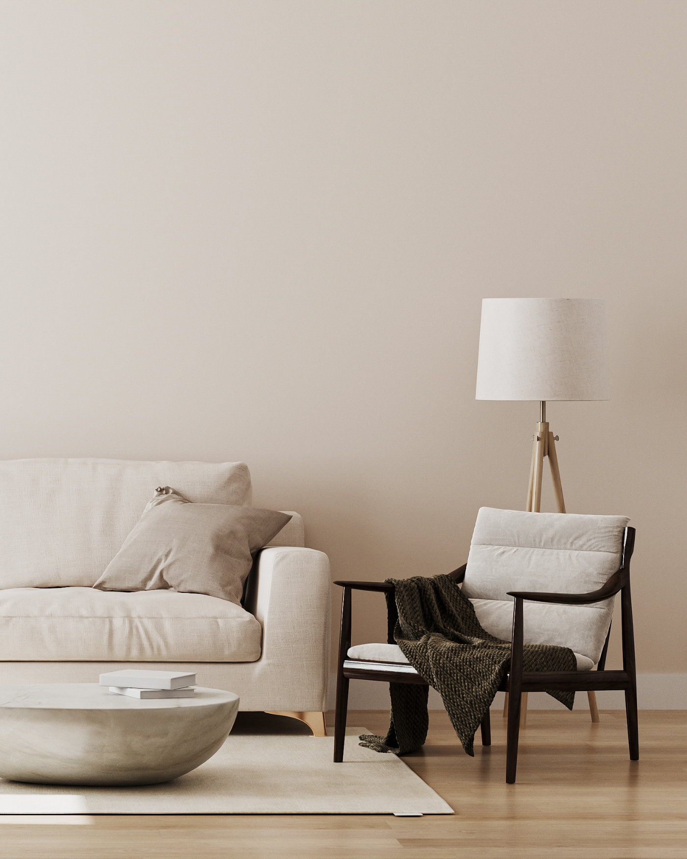 Modern living room with a sofa, armchair, and lamp against a plain wall.