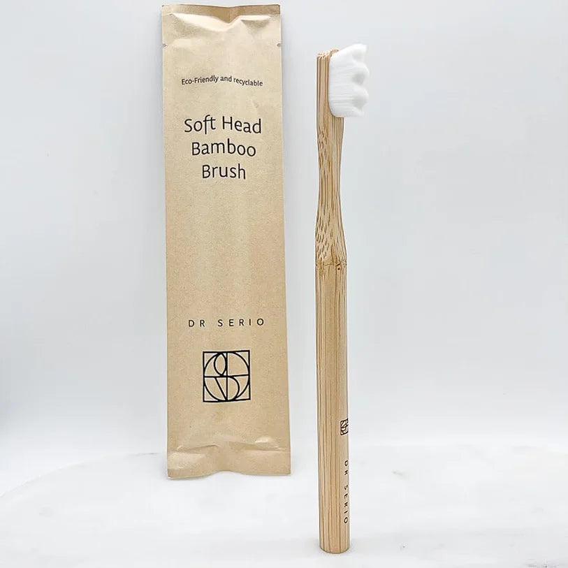 Bamboo toothbrush with soft head and packaging on white background