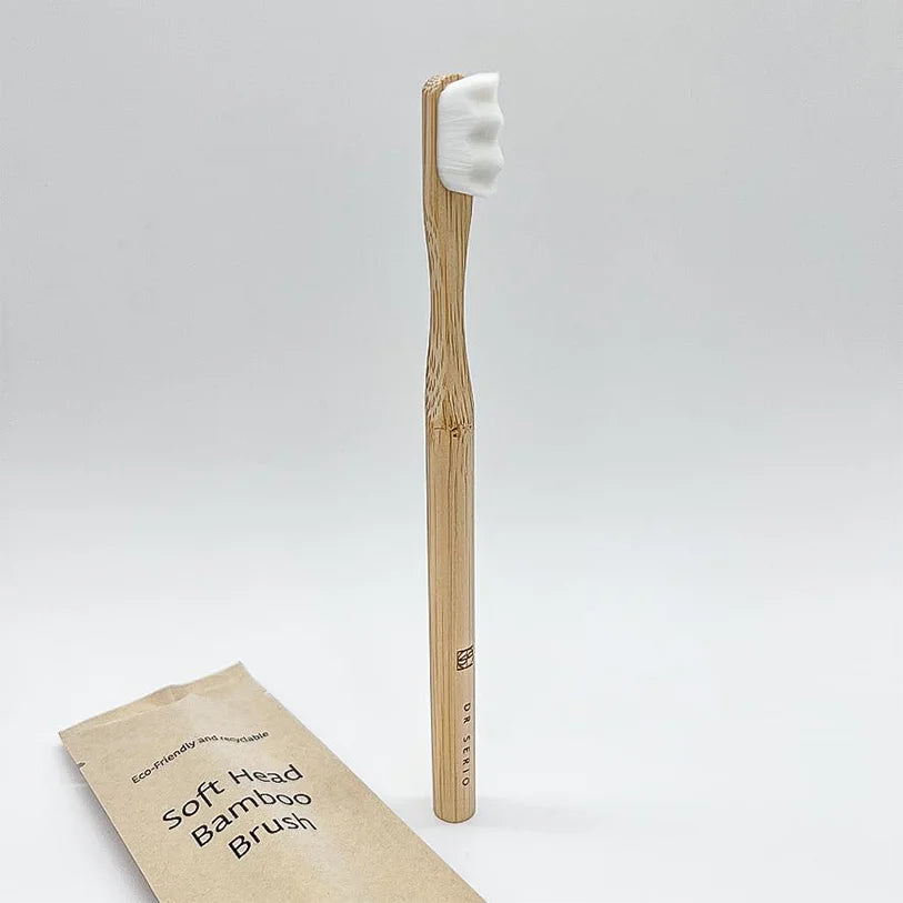 Bamboo toothbrush with soft head and packaging on white background