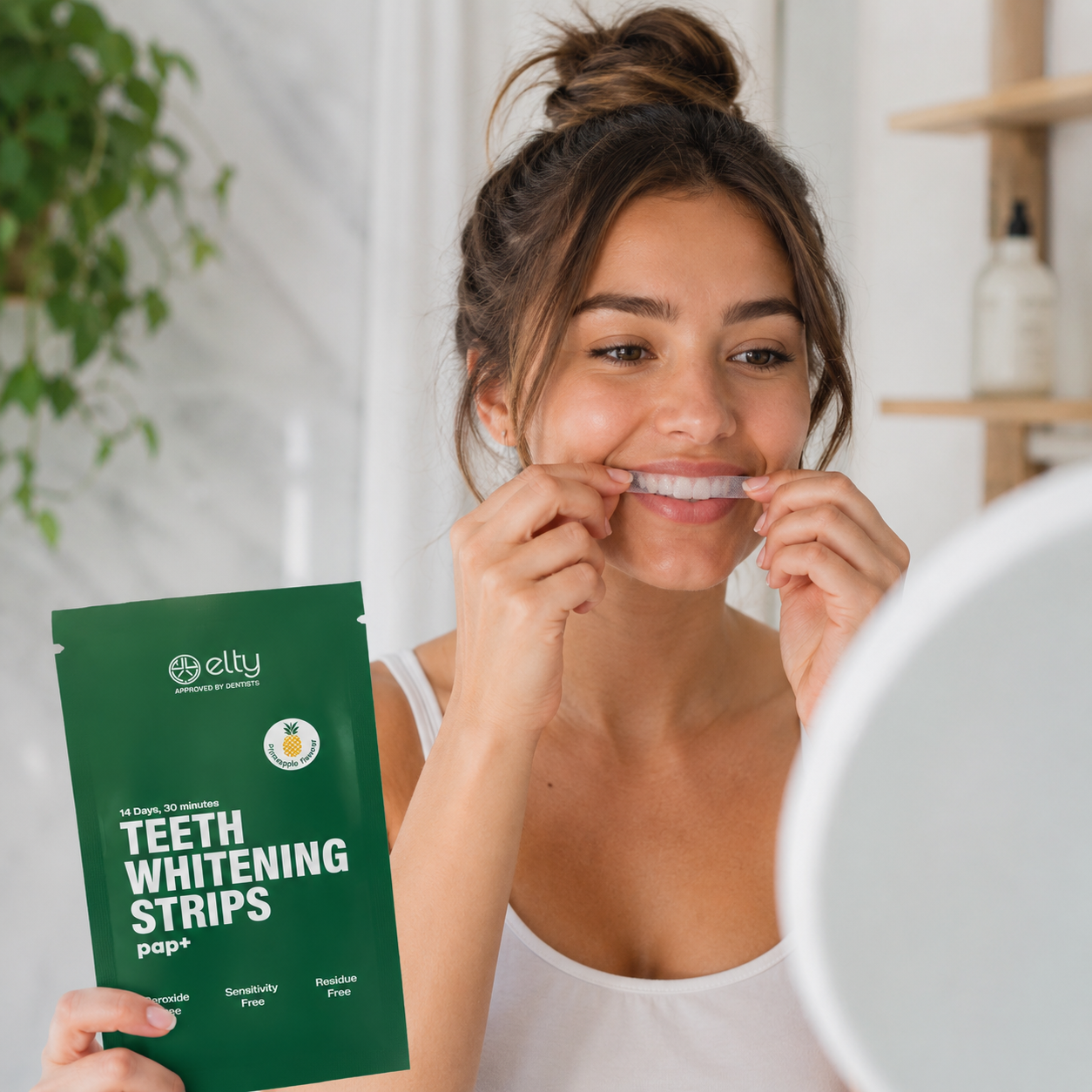 Woman applying Elty PAP+ whitening strips