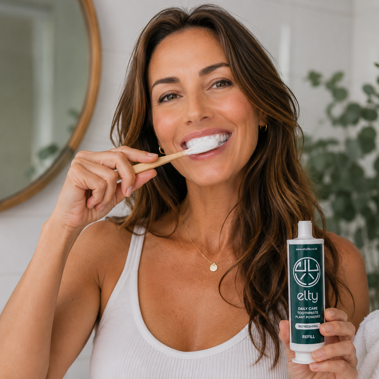 Woman brushing with Elty toothpaste — bright natural smile